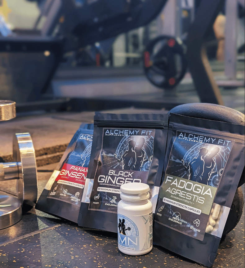 Supplement packages and a bottle on a counter with a blurred background